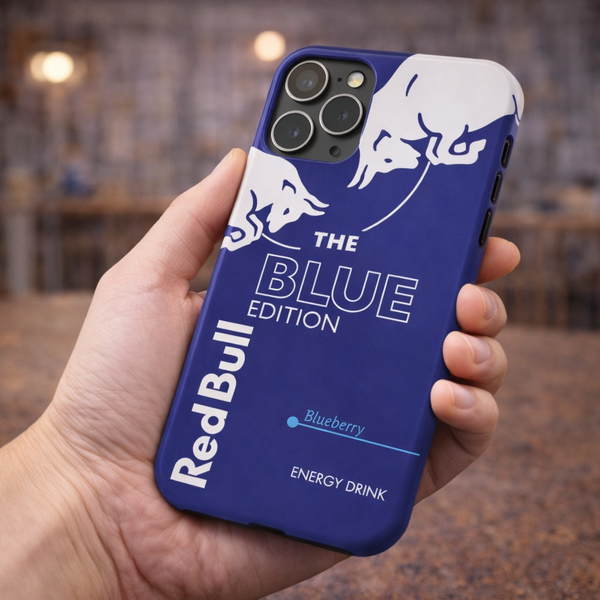 Blue Red Bull phone case with white logo held in a hand against a blurred indoor background